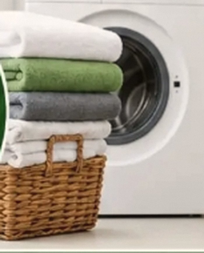 Folded laundry beside a washing machine